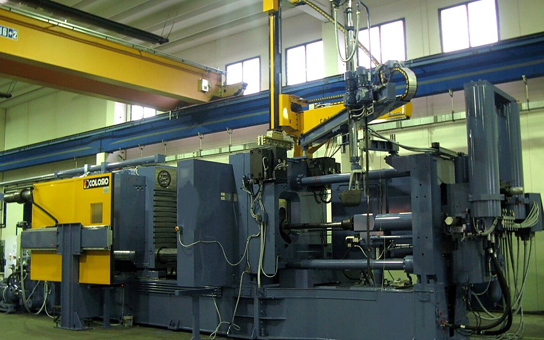 Cold-chamber die casting machine with the die closed and the extraction robot in position